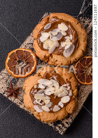 Round cookies with nuts and chocolate butter Round cookies with nuts and chocolate butter 124311697