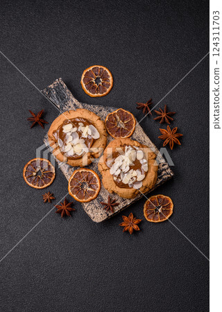 Round cookies with nuts and chocolate butter 124311703