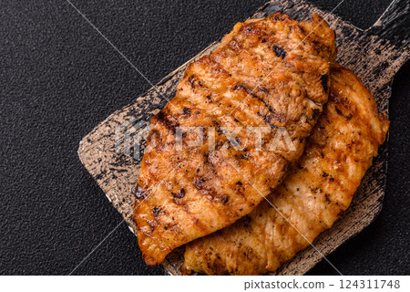 Delicious fresh grilled chicken fillet with spices and herbs Delicious fresh grilled chicken fillet with spices and herbs 124311748