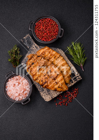 Delicious fresh grilled chicken fillet with spices and herbs Delicious fresh grilled chicken fillet with spices and herbs 124311755