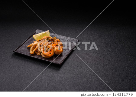 Rice with shrimps and seafood, vegetables, spices and soy sauce 124311779