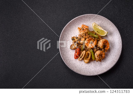 Rice with shrimps and seafood, vegetables, spices and soy sauce 124311783