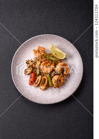 Rice with shrimps and seafood, vegetables, spices and soy sauce 124311784