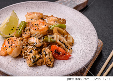 Rice with shrimps and seafood, vegetables, spices and soy sauce Rice with shrimps and seafood, vegetables, spices and soy sauce 124311787