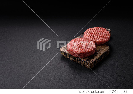 Fresh raw ground beef burger patty with salt and spices Fresh raw ground beef burger patty with salt and spices 124311831