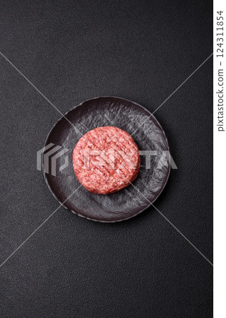Fresh raw ground beef burger patty with salt and spices Fresh raw ground beef burger patty with salt and spices 124311854