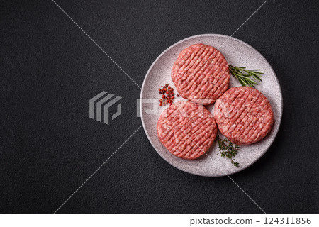 Fresh raw ground beef burger patty with salt and spices Fresh raw ground beef burger patty with salt and spices 124311856