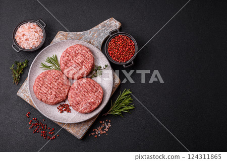 Fresh raw ground beef burger patty with salt and spices 124311865