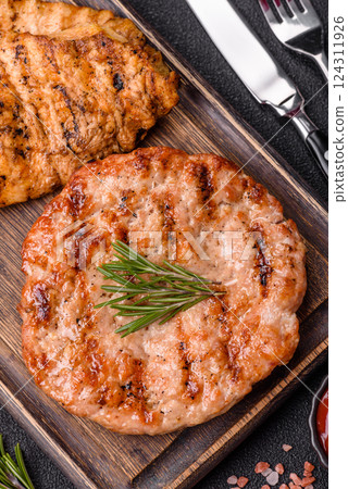 Delicious fresh grilled turkey fillet with spices and herbs Delicious fresh grilled turkey fillet with spices and herbs 124311926