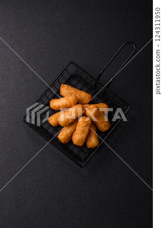 Delicious crispy cheese sticks with mozzarella, salt and spices Delicious crispy cheese sticks with mozzarella, salt and spices 124311950