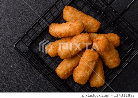 Delicious crispy cheese sticks with mozzarella, salt and spices Delicious crispy cheese sticks with mozzarella, salt and spices 124311952