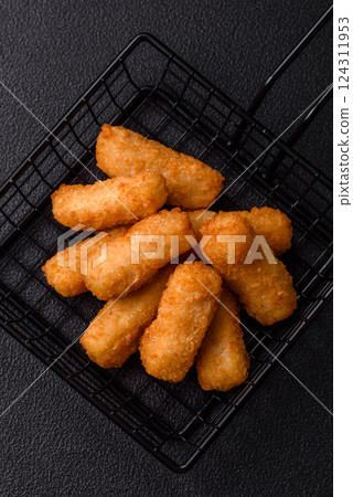 Delicious crispy cheese sticks with mozzarella, salt and spices 124311953