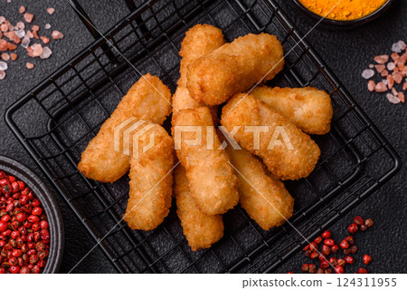 Delicious crispy cheese sticks with mozzarella, salt and spices 124311955