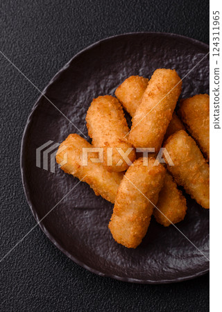 Delicious crispy cheese sticks with mozzarella, salt and spices 124311965