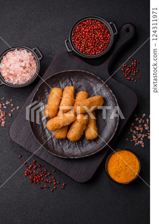 Delicious crispy cheese sticks with mozzarella, salt and spices Delicious crispy cheese sticks with mozzarella, salt and spices 124311971
