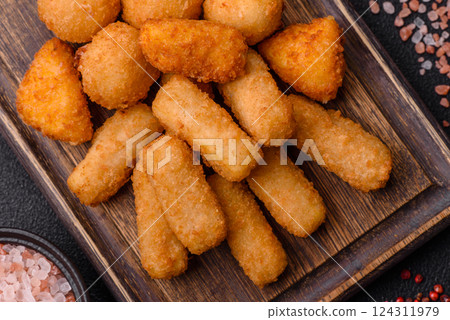Delicious crispy cheese sticks with mozzarella, salt and spices 124311979