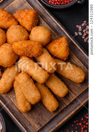 Delicious crispy cheese sticks with mozzarella, salt and spices 124311980
