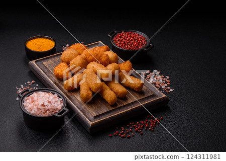 Delicious crispy cheese sticks with mozzarella, salt and spices 124311981