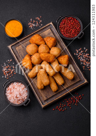 Delicious crispy cheese sticks with mozzarella, salt and spices Delicious crispy cheese sticks with mozzarella, salt and spices 124311983