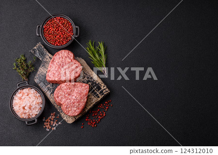Raw beef or pork burger patty in the shape of a heart Raw beef or pork burger patty in the shape of a heart 124312010