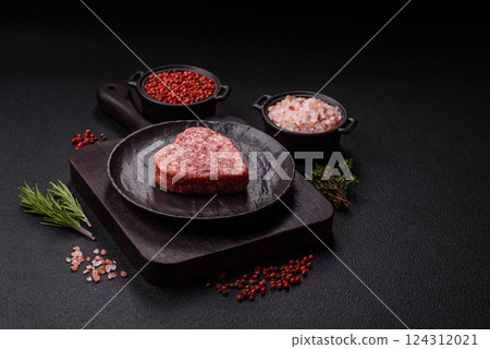 Raw beef or pork burger patty in the shape of a heart Raw beef or pork burger patty in the shape of a heart 124312021