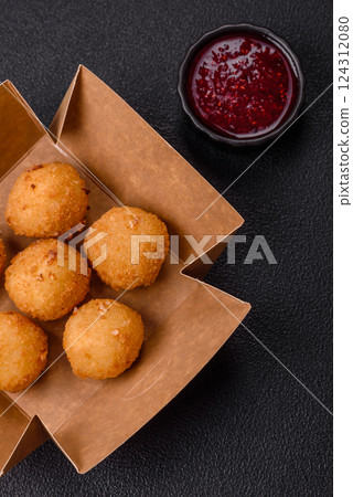 Crispy French fries with mozzarella cheese with raspberry sauce 124312080