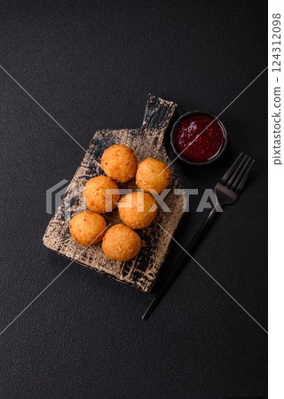 Crispy French fries with mozzarella cheese with raspberry sauce 124312098