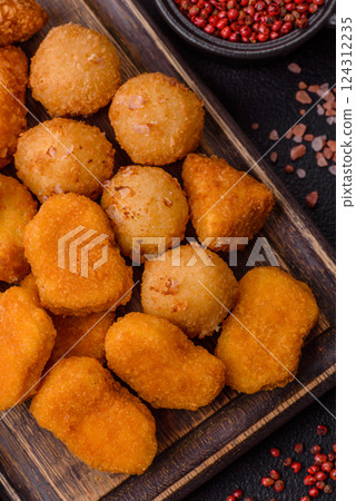 Fast food brie fries, cheese balls and chicken nuggets Fast food brie fries, cheese balls and chicken nuggets 124312235