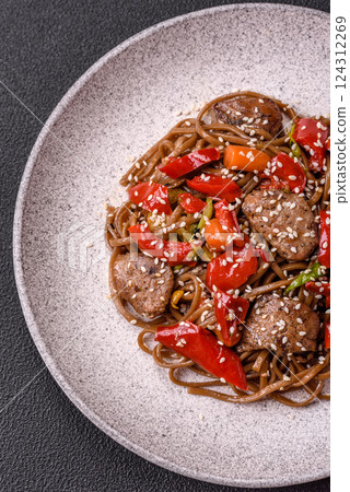 Delicious spicy Asian food soba with buckwheat noodles, beef, vegetables Delicious spicy Asian food soba with buckwheat noodles, beef, vegetables 124312269