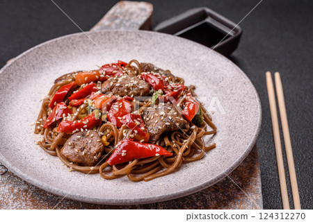 Delicious spicy Asian food soba with buckwheat noodles, beef, vegetables Delicious spicy Asian food soba with buckwheat noodles, beef, vegetables 124312270
