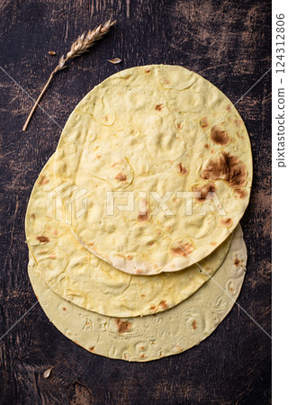 Lavash flat bread on green background 124312806