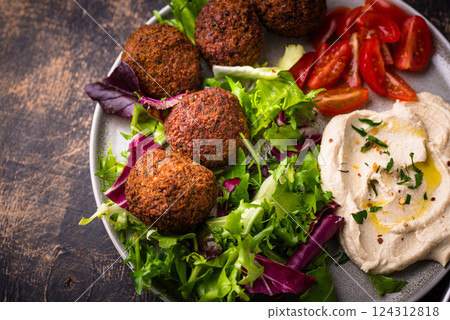 Salad with hummus, falafel and vegetables 124312818