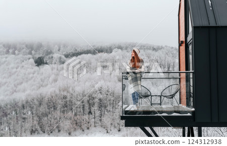 Woman Enjoying Views from Terrace in Winter Woman Enjoying Views from Terrace in Winter 124312938