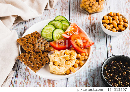 Vegetarian plate with chickpeas and vegetables on the table Vegetarian plate with chickpeas and vegetables on the table 124313297