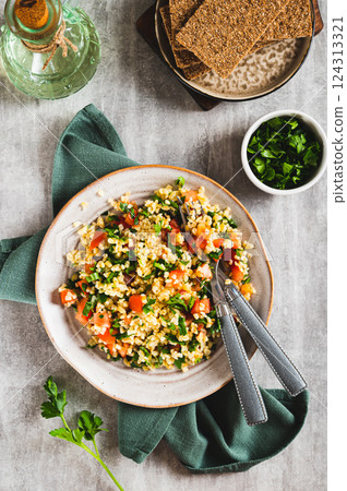 Traditional vegetarian tabbouleh salad on a plate on the table top and vertical view 124313321