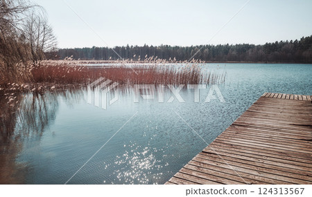 Landscape with a lake on a sunny day, color toning applied. Landscape with a lake on a sunny day, color toning applied. 124313567