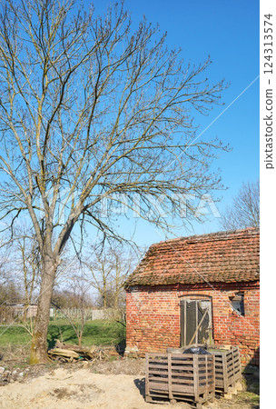 Old abandoned red brick building in the countryside. 124313574