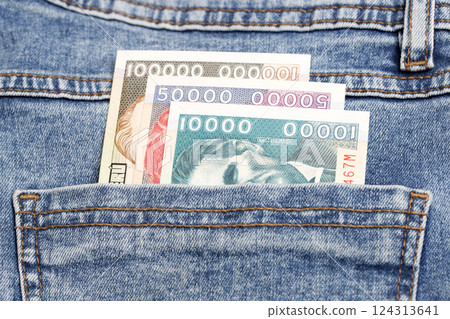 Old Peruvian sol in the pocket of blue jeans Old Peruvian sol in the pocket of blue jeans 124313641