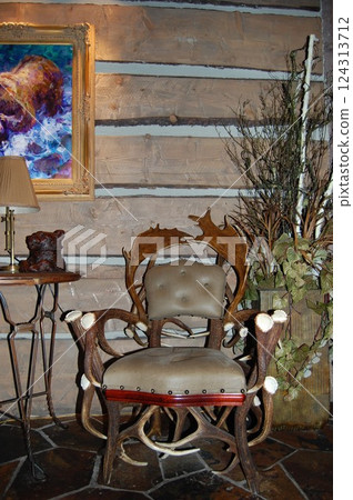 Rustic interior featuring a handcrafted antler chair Rustic interior featuring a handcrafted antler chair 124313712