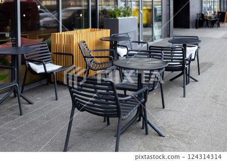 Outdoor street cafe tables ready for service. Empty cafe terrace with table and plastic chair, morning time. Food concept 124314314