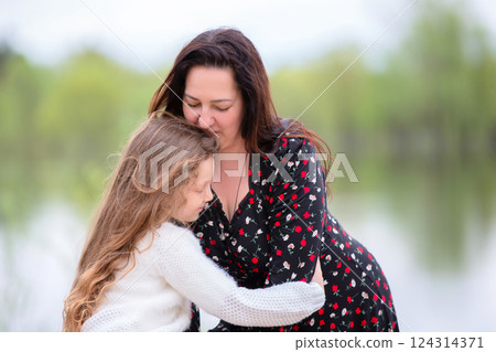 Mom and daughter enjoy a walk in the park on Mother's Day. 124314371