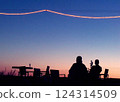 Cozy summer evening, two friends spending time together on a roof bar silhouette 124314509