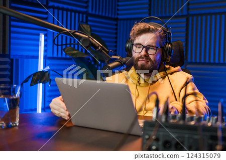 Handsome man radio DJ hosting a radio show, entertainment and communication concept Handsome man radio DJ hosting a radio show, entertainment and communication concept 124315079