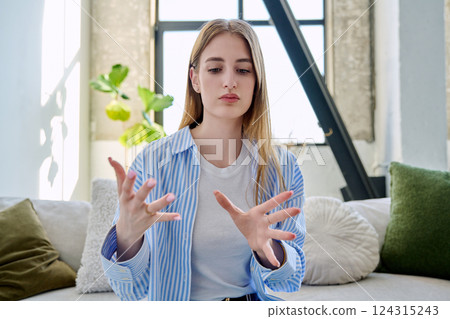 Web camera view of teenage girl talking looking in camera, online meeting, video call Web camera view of teenage girl talking looking in camera, online meeting, video call 124315243