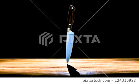 Sharp knife stabbed into wooden table on dark background 124316958