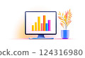 Modern computer displaying colorful bar graph with decorative plant 124316980