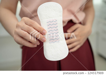 Asian woman holding sanitary napkin pad for hygiene menstrual period cycle protection. Asian woman holding sanitary napkin pad for hygiene menstrual period cycle protection. 124317989