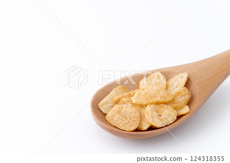 Close-up of garlic chips on a wooden spoon Close-up of garlic chips on a wooden spoon 124318355