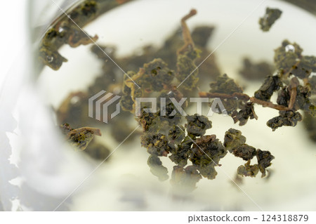 Close-up of Dongding Oolong tea leaves being brewed 124318879