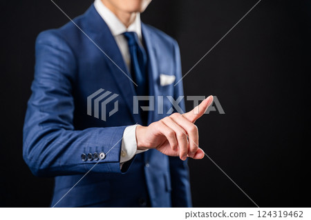 Businessman pointing with index finger - black background Businessman pointing with index finger - black background 124319462